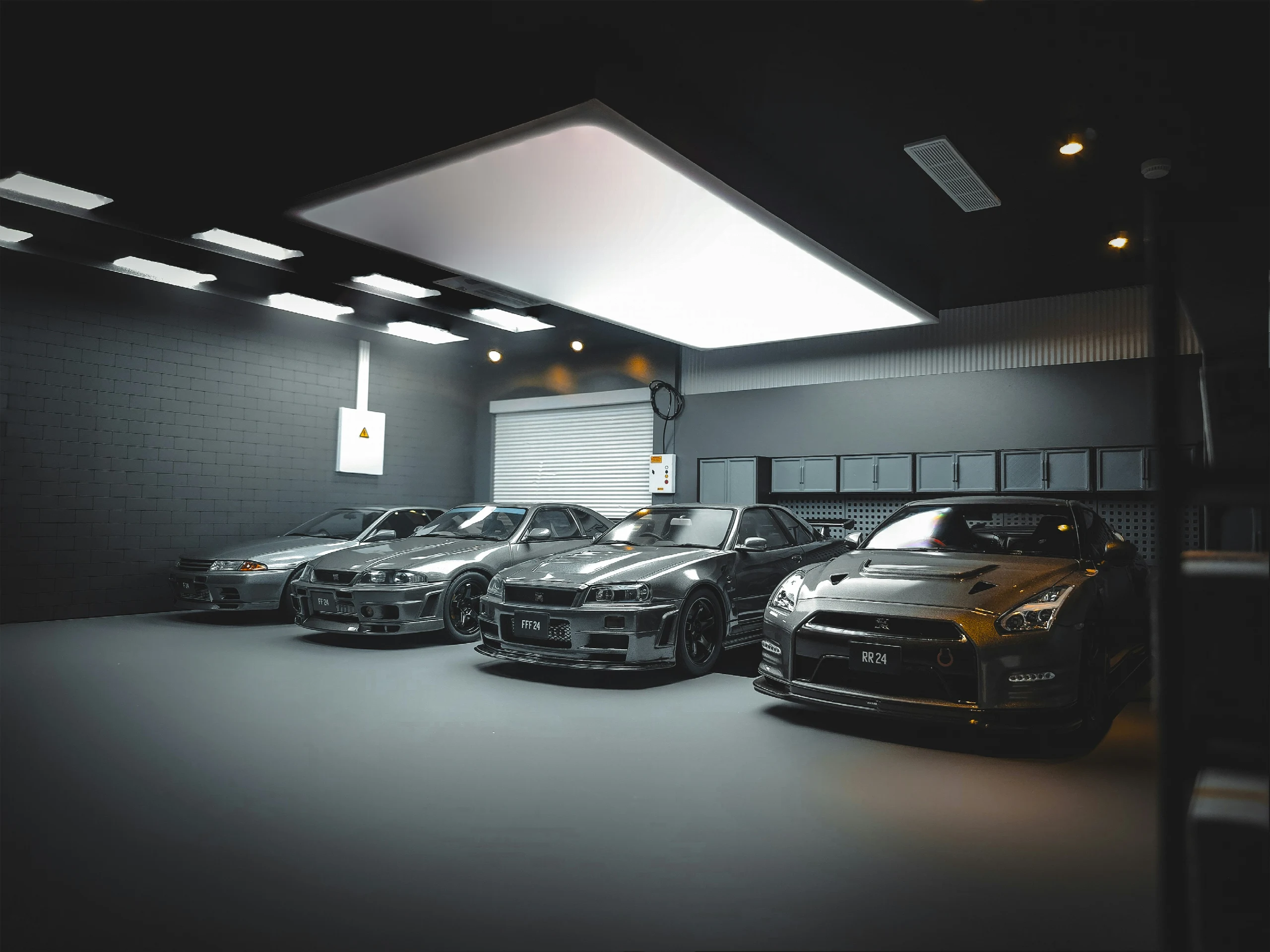 Four performance cars parked inside a garage